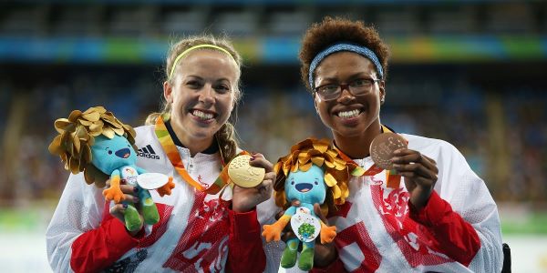 Two TeamGB athletes holding medals
