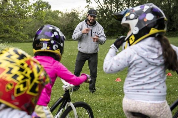 Coach chats to young BMX cyclists