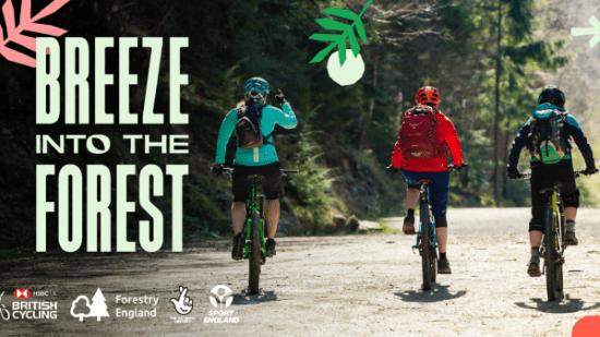 three ladies riding into the forest on bikes
