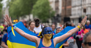 A runner wears a Ukrainian flag and face paint as she takes part in the ‘Run for Ukraine’ wave.