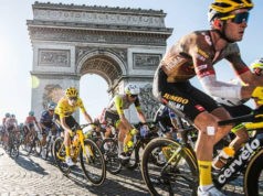 Cyclists ride past the Arc de Triomphe in Paris