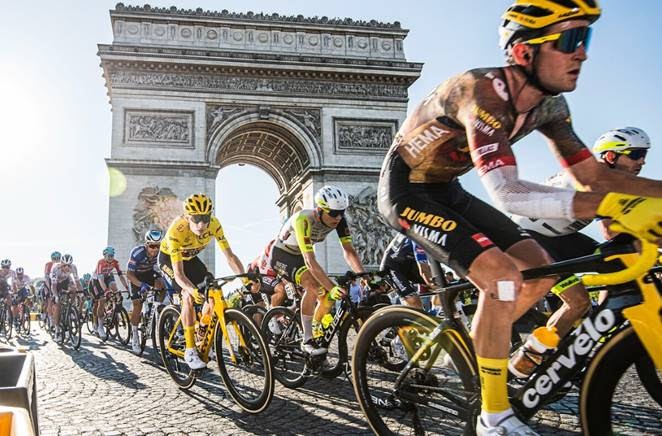 Cyclists ride past the Arc de Triomphe in Paris