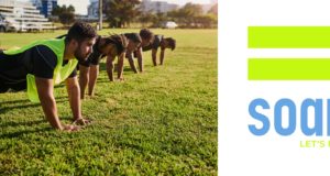 a group of runners performing core strength exercises in a park