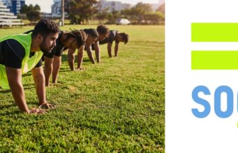 a group of runners performing core strength exercises in a park