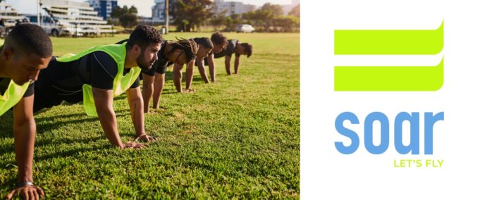 a group of runners performing core strength exercises in a park