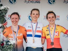 Three female athletes smile on the podium