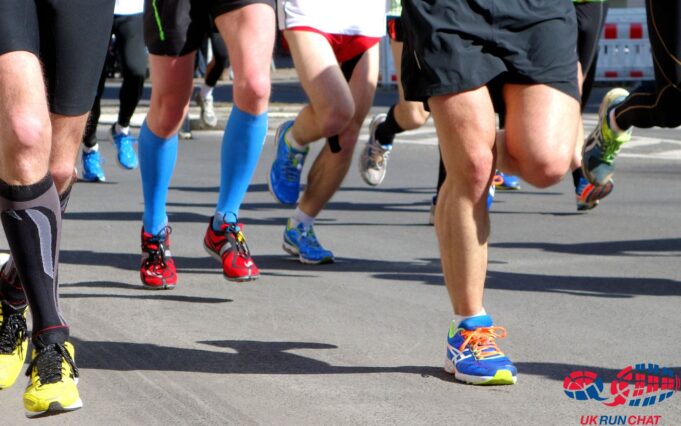 Runners legs taking part in a running race. Lots of coloured running shoes on show