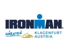 Logo with the words Ironman Karnten Klagenfurt Austria, and a rough drawing of the outline of some mountains.