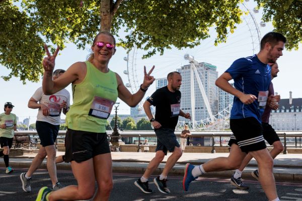 Runners running past the London Eye big wheel