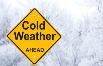 cold weather sign with a snowy background