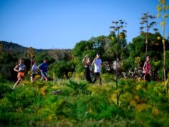 Runners in lush Mediterranean foliage look happy as they run by