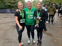 Three ladies in running kit smile, with medals around their necks