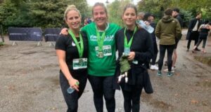 Three ladies in running kit smile, with medals around their necks