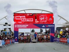 The start of Manchester Marathon, contestants wait on the start line under a gantry