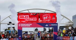 The start of Manchester Marathon, contestants wait on the start line under a gantry