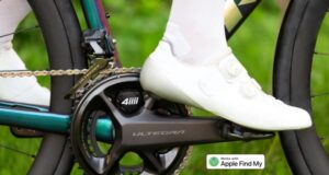 A close up of a white cycling shoe pedalling