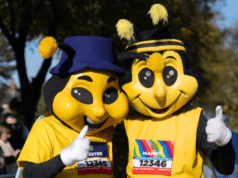 Two people dressed in bee outfits with the names Manny and Chester