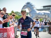 Female triathlete runs down finish straight