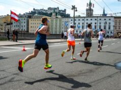 Elite men run along an Austrian street