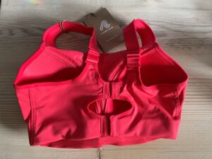 back of vibrant red sports bra shows two fastening points