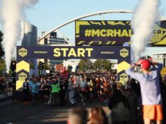 start line of the manchester half marathon with runners under a START line gantry