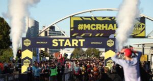 start line of the manchester half marathon with runners under a START line gantry