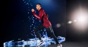 Male runner 'runs' in a black studio with what appears to be water behind him
