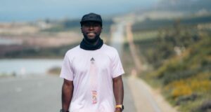 Man stands on African road in running kit