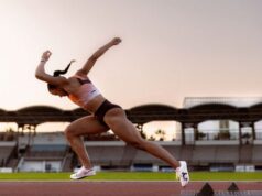 Woman springs off the block on a track looking immensely powerful