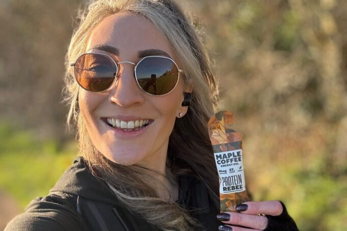 Young female runners holds maple coffee gel