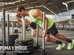 Man and woman push weights plates on a gym sled