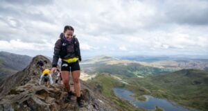 Woman crosses a very high rocky ridge