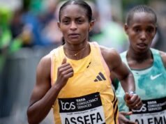 Woman in yellow runs slightly ahead of woman in green