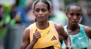 Woman in yellow runs slightly ahead of woman in green