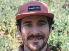 Close up of bearded man wearing pink Salomon cap