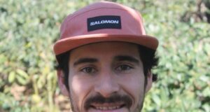 Close up of bearded man wearing pink Salomon cap