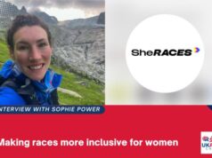 A female runner in a blue jacket smiles at the camera. Graphic also shows SheRACES logo and the words Interview with Sophie Power: Making races more inclusive for women.