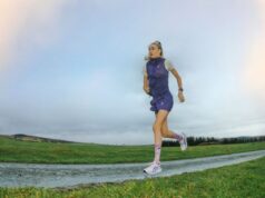 Blonde runner with ponytail runs along a road in a deserted place