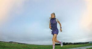 Blonde runner with ponytail runs along a road in a deserted place