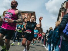 Runners in a race waving at the camera