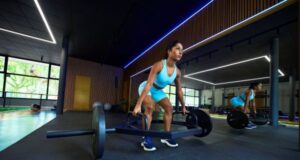 Woman wearing blue crop top and shorts lifts a heavy weight
