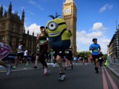 Runners - including one dressed as a minion - run past the Elizabeth Tower and the Houses of Parliament