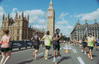 Runners on road in London with Elizabeth Tower in background