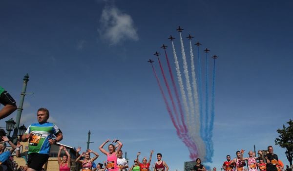 Great North Run 2027 Ballot Open The Red Arrows fly overhead a lot of colourful runners with their red, white and blue smoke on