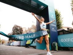 Female runner breaks through finish tape