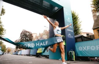 Female runner breaks through finish tape