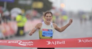 Women runs towards finish tape