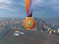 A medal on a roof above New York with a view of the city below