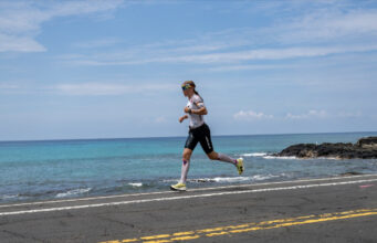 Female athletes runs by a tropical blue sea