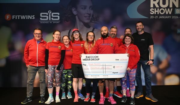 Apply for a National Running Show grant A group of people wearing red tops hold a large cheque